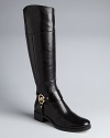 MICHAEL Michael Kors finishes off these riding boots with bold logo plate harness details that spell stylish.