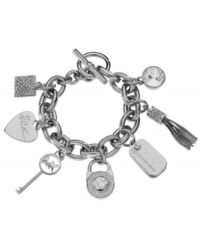 Bring on the charm. Make the perfect first impression with this designer style from Michael Kors. Crafted in silver tone mixed metal, bracelet features a variety of signature charms and Czech crystals with a trendy toggle clasp. Approximate length: 8 inches. Approximate charm drops: 1/2 inch to 1 inch. Bring on the charm. Make the perfect first impression with this designer style from Michael Kors. Crafted in silver tone mixed metal, bracelet features a variety of signature charms and Czech crystals with a trendy toggle clasp. Approximate length: 8 inches. Approximate charm drops: 1/2 inch to 1 inch.