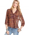 Stylishly slouchy, this floral-print Free People blouse looks effortlessly chic atop distressed denim!