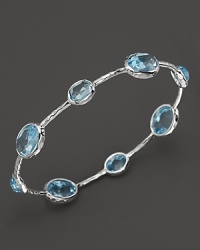 Blue topaz stations sparkle on this textured sterling silver bangle from Ippolita. Blue topaz stations sparkle on this textured sterling silver bangle from Ippolita.