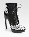 A towering horn heel lifts this leather and velvet ankle boot, accented with dramatically embroidered lace. Leather-covered heel, 5¼ (130mm)Leather covered platform, 1 (25mm)Compares to a 4¼ heel (110mm)Leather and velvet upper with lace overlayLeather lining and solePadded insoleMade in Italy