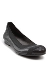 Treat yourself or a loved one to pretty leather ballet flats with black elastic trim along toe and opening.