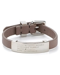 Inspired by surplus style, this MARC BY MARC JACOBS bracelet flaunts a commanding mix of leather and brass. Slip it on to flash your fashion credentials.