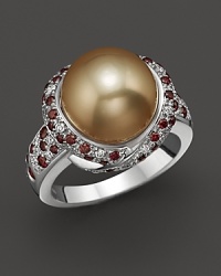 Thickly scattered white and brown diamonds frame a golden cultured pearl set in 18K white gold. Thickly scattered white and brown diamonds frame a golden cultured pearl set in 18K white gold.