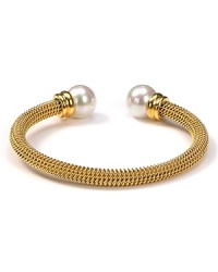 Majorica's gold bangle exudes cool confidence. Solo or stacked, wear yours at cocktail hour to give night time looks a strong spin. Majorica's gold bangle exudes cool confidence. Solo or stacked, wear yours at cocktail hour to give night time looks a strong spin.
