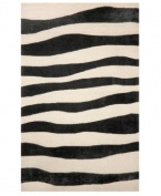 A suggested zebra stripe adds a hint of wild energy to the Promenade Wavey Stripe area rug, while its tame color palette lends itself to any modern home décor. This unique home accent is intricately hand-tufted for crafted durability and supreme detailing in composition.