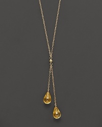 Twin citrine briolettes sparkle from this 14K yellow gold lariat necklace. Twin citrine briolettes sparkle from this 14K yellow gold lariat necklace.