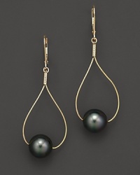 Sleek gold teardrops pierce black Tahitian pearls. Sleek gold teardrops pierce black Tahitian pearls.