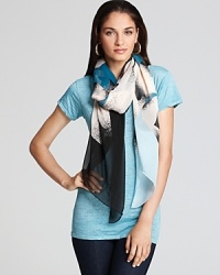 Cream flowers pop against the blue-to-black ombre background of this DIANE von FURSTENBERG scarf. Cream flowers pop against the blue-to-black ombre background of this DIANE von FURSTENBERG scarf.