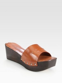 Sprinkled in studs, this traditional leather style has a slight wooden wedge and platform. Wooden wedge, 2½ (65mm)Wooden platform, 1½ (40mm)Compares to a 1 heel (25mm)Leather upperLeather lining and solePadded insoleMade in ItalyOUR FIT MODEL RECOMMENDS ordering one half size up as this style runs small. Sprinkled in studs, this traditional leather style has a slight wooden wedge and platform. Wooden wedge, 2½ (65mm)Wooden platform, 1½ (40mm)Compares to a 1 heel (25mm)Leather upperLeather lining and solePadded insoleMade in ItalyOUR FIT MODEL RECOMMENDS ordering one half size up as this style runs small.