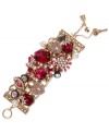 Embrace your versatile side with Betsey Johnson's statement-making toggle bracelet. Crafted in antique gold tone mixed metal, this wide multi-link bracelet features fuchsia-colored crystal gems, glass pearls, gold tone heart lock with pink-colored crystal accents and hematite crystals with crown base. Approximate length: 7-1/2 inches.