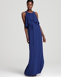 Revel in red carpet style. This ruffled BCBGMAXAZRIA gown, flaunting an exposed back, cinched waistline and flowing, floor-length skirt, is a stellar standout at your next special evening occasion. Revel in red carpet style. This ruffled BCBGMAXAZRIA gown, flaunting an exposed back, cinched waistline and flowing, floor-length skirt, is a stellar standout at your next special evening occasion.