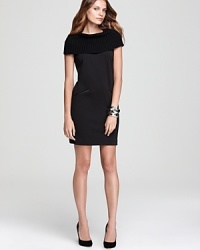 The classic LBD gets contemporary attitude as an oversized ribbed neckline and faux-leather trim modernize a Calvin Klein shift dress. The classic LBD gets contemporary attitude as an oversized ribbed neckline and faux-leather trim modernize a Calvin Klein shift dress.