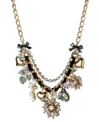 Turn on the charm with this funky frontal necklace from Betsey Johnson. Fabulously flaunts gold tone flowers with crystal accents and glass pearls, blue lightning bugs with crystal accents, gold tone bubble hearts, gold tone leaves with blue-colored crystal accents, blue faceted beads, glass pearls and hematite plated bows with crystal accents. Crafted in gold tone mixed metal intertwined with black grosgrain ribbon and crystal cup chain accents. Approximate length: 16 inches + 3-inch extender. Approximate drop: 2 inches. Turn on the charm with this funky frontal necklace from Betsey Johnson. Fabulously flaunts gold tone flowers with crystal accents and glass pearls, blue lightning bugs with crystal accents, gold tone bubble hearts, gold tone leaves with blue-colored crystal accents, blue faceted beads, glass pearls and hematite plated bows with crystal accents. Crafted in gold tone mixed metal intertwined with black grosgrain ribbon and crystal cup chain accents. Approximate length: 16 inches + 3-inch extender. Approximate drop: 2 inches.