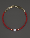 Diamonds and blue sapphires in 14K. yellow gold from a dazzling evil eye charm, strung on red rope. By Meira T.