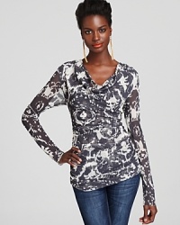 Casual elegance is yours with this printed Sweet Pea top, enriched with a draped cowl neckline and flattering ruched details. Casual elegance is yours with this printed Sweet Pea top, enriched with a draped cowl neckline and flattering ruched details.