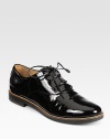 A menswear-inspired silhouette in patent leather with charming laces. Stacked heel, 1 (25mm)Patent leather upperLeather liningRubber solePadded insoleMade in Italy