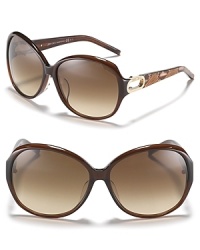 Turn heads in these oversized round sunglasses with open metal temples and reptile print along arms.