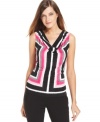 Calvin Klein goes graphic with a boldly colored striped print. The draped cowl neckline softens the look.