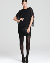 Venture to the dramatic side in a shimmering DKNY dress flaunting a sequin silhouette and sheer cape overlay. Slip the statement piece over black tights for serious fashion presence. Venture to the dramatic side in a shimmering DKNY dress flaunting a sequin silhouette and sheer cape overlay. Slip the statement piece over black tights for serious fashion presence.