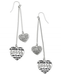 Accessorize with lovely style. These GUESS linear earrings swing with heart charms detailed with jet epoxy logos and crystal accents. Crafted in silver tone mixed metal. Approximate drop: 3-1/4 inches. Accessorize with lovely style. These GUESS linear earrings swing with heart charms detailed with jet epoxy logos and crystal accents. Crafted in silver tone mixed metal. Approximate drop: 3-1/4 inches.