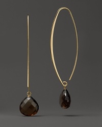 Faceted drops of smoky quartz dangle from slim oval hoops of 14K yellow gold. Faceted drops of smoky quartz dangle from slim oval hoops of 14K yellow gold.