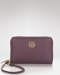 Tory Burch meets the need for wholly modern accessories. This iPhone wallet flaunts an enviably practical design with space for your gadget and pockets for the essentials.