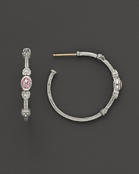 Faceted, oval-shaped pink crystals, flanked by hearts, bring romantic glamour to classic sterling silver hoop earrings. Faceted, oval-shaped pink crystals, flanked by hearts, bring romantic glamour to classic sterling silver hoop earrings.