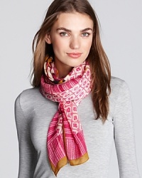 A lush floral print framed by geometric patterns and stripes adorns this chic silk-and-wool scarf from Tory Burch. A lush floral print framed by geometric patterns and stripes adorns this chic silk-and-wool scarf from Tory Burch.