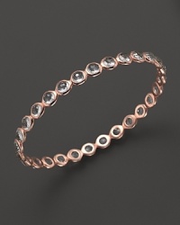 Clear quartz stations dot a polished rose gold bangle from Ippolita.