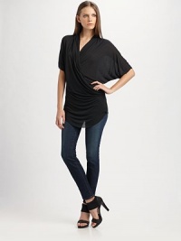 Wrap-front jersey top drapes to one hip, dipping lower at front hem.V-neck pullover Side draping Short dolman sleeves Asymmetrical hem About 31 long Micro modal; dry clean Imported
