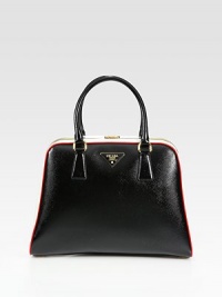 Saffiano leather framed style with metal logo detail. Double top handles, 5½ dropTop clasp closureProtective metal feetTwo inside zip pocketsThree inside open pocketsLeather lining12¾W X 9¾H X 3½DMade in Italy Saffiano leather framed style with metal logo detail. Double top handles, 5½ dropTop clasp closureProtective metal feetTwo inside zip pocketsThree inside open pocketsLeather lining12¾W X 9¾H X 3½DMade in Italy