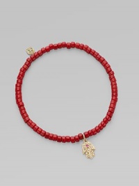 The hamsa, a traditional protective amulet, is encrusted with diamonds and accented with one ruby as it hangs from a stretchy strand of richly colored coral beads. Diamonds, 0.05 tcw Coral 14k yellow gold Diameter, about 2 (unstretched) Charm length, about ½ Imported The hamsa, a traditional protective amulet, is encrusted with diamonds and accented with one ruby as it hangs from a stretchy strand of richly colored coral beads. Diamonds, 0.05 tcw Coral 14k yellow gold Diameter, about 2 (unstretched) Charm length, about ½ Imported