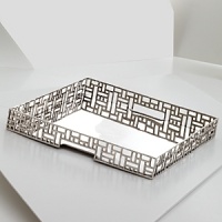Dozens of square and rectangular cutouts give this serving tray from Natori a modern, dimensional look. Dozens of square and rectangular cutouts give this serving tray from Natori a modern, dimensional look.
