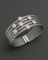 Diamonds set in white gold on a stainless steel bangle. By Charriol. Diamonds set in white gold on a stainless steel bangle. By Charriol.