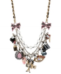The reel deal. Betsey Johnson takes you to the movies with this frontal statement necklace. Crafted from gold-tone mixed metal and grosgrain ribbon, the necklace screams Action! with a number of glass accent charms. Approximate length: 16 inches + 3-inch extender. Approximate drop: 2-3/4 inches.