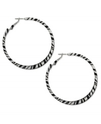 Answer the call of the wild. Bold zebra stripes in black enamel adorn this fierce hoop style from Style&co. Crafted in silver tone mixed metal. Approximate diameter: 2-1/4 inches.