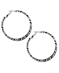 Answer the call of the wild. Bold zebra stripes in black enamel adorn this fierce hoop style from Style&co. Crafted in silver tone mixed metal. Approximate diameter: 2-1/4 inches. Answer the call of the wild. Bold zebra stripes in black enamel adorn this fierce hoop style from Style&co. Crafted in silver tone mixed metal. Approximate diameter: 2-1/4 inches.