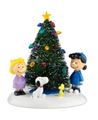 The cutest kids from Peanuts Village get together to decorate the Christmas tree, stringing lights and singing carols in a scene that would even raise Charlie Brown's spirits. From Department 56. The cutest kids from Peanuts Village get together to decorate the Christmas tree, stringing lights and singing carols in a scene that would even raise Charlie Brown's spirits. From Department 56.