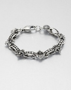 A remarkably detailed fleur de lis of sterling silver and skull charm accents a simple, sophisticated sterling silver bracelet.Sterling silverWidth, about 8mmDiameter, about 3Lobster claspMade in USA