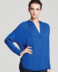 Minimalist design makes a strong showing with this Vince top. Beautifully basic, this blouse can be dressed up or down for any time of day.