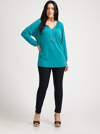 Flattering and feminine, this tunic features an elasticized neckline and cuffs. Its relaxed fit and unique chain detail will make this design one of your favorites.Self-tie necklineDolman sleevesPull-on styleGathered details at backAbout 30 from shoulder to hem95% polyester/5% spandexMachine washImported