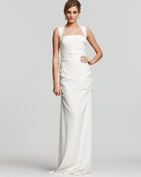 The lace-detailed square neck and cutout back of this gown from Nicole Miller make for a truly unique and elegant silhouette. The lace-detailed square neck and cutout back of this gown from Nicole Miller make for a truly unique and elegant silhouette.