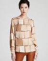 A three-dimensional square print decorates this silk Escada top for eclectic chic.