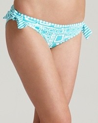 Bring an artsy look to the beach with Tommy Bahama's cube printed bikini, a graphic print in cool curacao blue--reversible to striking stripes. Bring an artsy look to the beach with Tommy Bahama's cube printed bikini, a graphic print in cool curacao blue--reversible to striking stripes.
