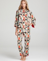 Take a trip across the globe in Natori's Eastern-inspired print pajamas with a Mandarin collar and front button closure. Take a trip across the globe in Natori's Eastern-inspired print pajamas with a Mandarin collar and front button closure.