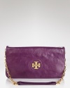 Tory Burch's signature logo plaque dresses up this luxe vegan leather clutch. Carry it to take the label's city sleek style out for the night.