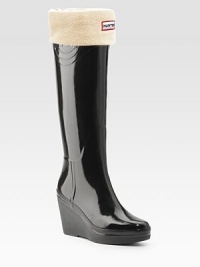 Glossy rubber rainwear now revamped with an embossed Hunter crest and solid rubber wedge.Heel, 3 (75mm) Rubber platform, ½ (15mm) Compares to a 2½ heel (65mm) Shaft, 14 Leg circumference, 15 Round toe Pull-on style Padded insole Rubber sole ImportedOUR FIT MODEL RECOMMENDS ordering true whole size; ½ sizes should order the next whole size up. Glossy rubber rainwear now revamped with an embossed Hunter crest and solid rubber wedge.Heel, 3 (75mm) Rubber platform, ½ (15mm) Compares to a 2½ heel (65mm) Shaft, 14 Leg circumference, 15 Round toe Pull-on style Padded insole Rubber sole ImportedOUR FIT MODEL RECOMMENDS ordering true whole size; ½ sizes should order the next whole size up.