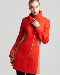 Embracing the season's color block trend, this Calvin Klein coat takes on a touch of edge with an asymmetric front zip and a funnel neck collar as seen on the runways. Add fashion-forward style to your workweek wardrobe or slip it over an LBD for cocktails.