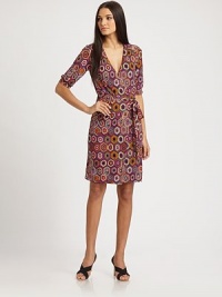 Fluid knit jersey in a flattering wrap style, patterned with a colorful, exotic print.Surplice necklineElbow-length sleeves with banded cuffsWrap front with sash tieAbout 21 from natural waistRayonDry cleanMade in USA of imported fabricModel shown is 5'10½ (179cm) wearing US size 4. Fluid knit jersey in a flattering wrap style, patterned with a colorful, exotic print.Surplice necklineElbow-length sleeves with banded cuffsWrap front with sash tieAbout 21 from natural waistRayonDry cleanMade in USA of imported fabricModel shown is 5'10½ (179cm) wearing US size 4.
